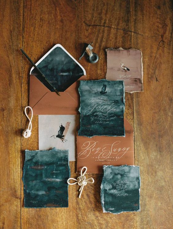 watercolor teal wedding invites and copper envelopes and cards for a moody coastal wedding