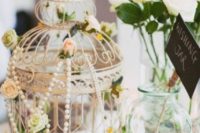 29 a vintage cage covered with pearl strands and florals on the outside