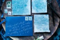 29 turquoise wedding invitations with white calligraphy and indigo envelopes