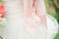 30 strapless wedding dress with a pink wedding cardigan with lace detailing and pearl buttons