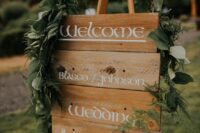 a LOTR-styled sign with a greenery garland over it is a cool idea for a fantasy wedding and you can make it yourself