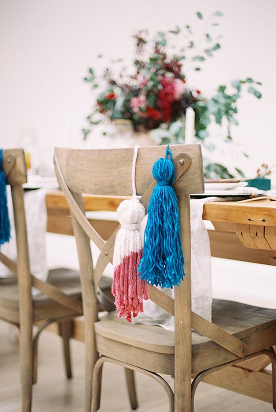 a blue and a colorful block pink tassel are a nice way to style your wedding chairs, they will add color and interest to it