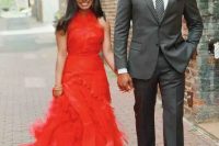 a bold hot red A-line wedding dress with a draped bodice and a layered skirt with a train plus a high neckline for a wedding with lots of color or to make a statement