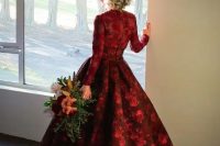 a deep red and burgundy floral print wedding ballgown with a high low skirt and a train, long sleeves for a fall or winter wedding