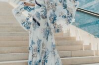 a fantastic A-line blue embroidery boho wedding dress with bell sleeves and a train plus navy tassels is a gorgeous idea for a boho bride