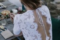 a fantastic boho lace A-line wedding dress with a high neckline, a keyhole back on ties with tassels and short sleeves is amazing