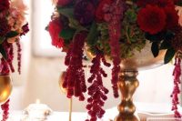 a fantastic wedding centerpiece of a gold bowl with lush red blooms and greenery and amaranthus is amazing
