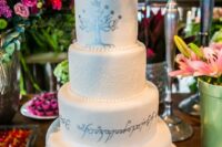 a fun LOTR wedding cake ith patterns and elvish letters, LEGO Arwen and Aragorn cake toppers