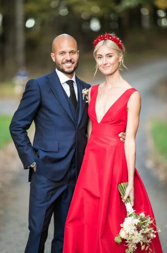 a hot red A-line wedding dress with thick straps, a deep neckline and a red floral headpiece for a bold modern wedding with a refined touch