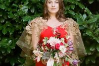 a hot red wedding dress with a unique gold floral capelet and a gold headpiece are a fantastic combo to rock at a wedding