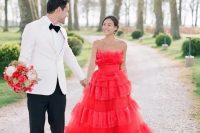 a jaw-dropping hot red strapless wedding ballgown with lots of ruffles is a fantastic way to make a statement and the dress is very trendy due to lots of ruffles