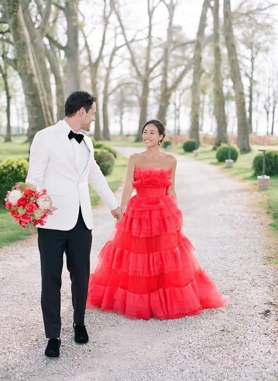 a jaw-dropping hot red strapless wedding ballgown with lots of ruffles is a fantastic way to make a statement and the dress is very trendy due to lots of ruffles