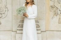 a lovely elegant casual bridal look with a white cardigan tucked into a white tulle skirt with a train and white shoes is chic