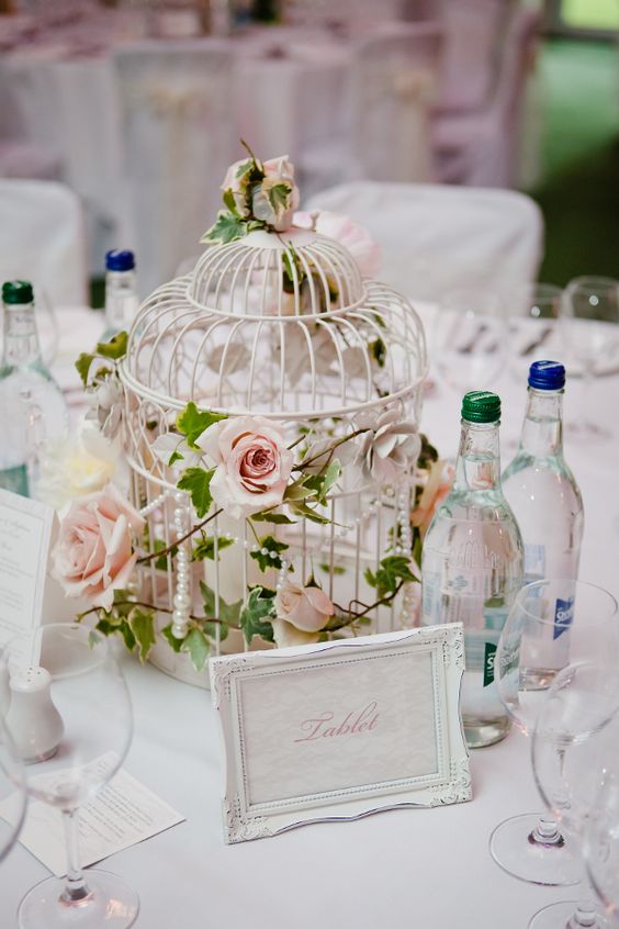 a refined white cage with blush roses and pearls is a chic idea for a vintage wedding