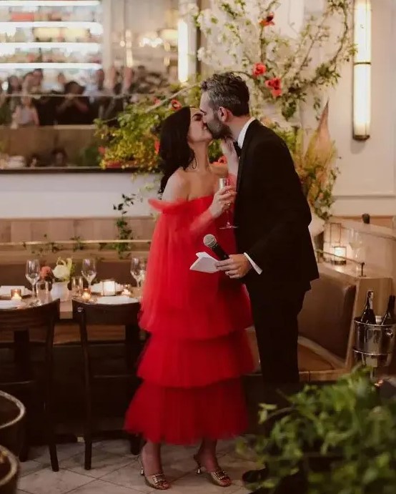 a unique off the shoulder red tea-length wedding dress with a tiered skirt and long wide sleeves is a fantastic idea to stand out