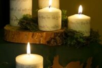 candles covered with elvish letters, moss and tree slices will be a great decoration for a LOTR wedding