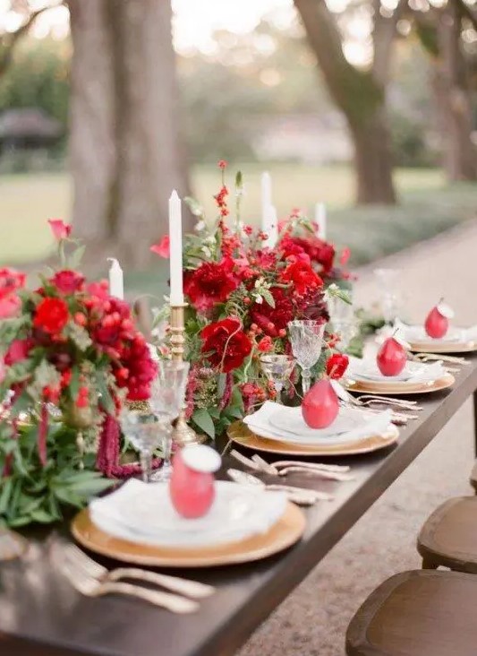 lush red florals and greenery and pears that hold the cards are amazing for styling your table for Halloween