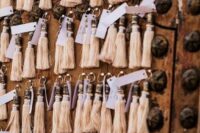neutral tassels with escort cards can also double as wedding favors, they look cute and chic and will fit a boho wedding