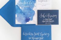 02 a beach wedding invitation suite with blue and navy envelopes, blue watercolor and silver calligraphy