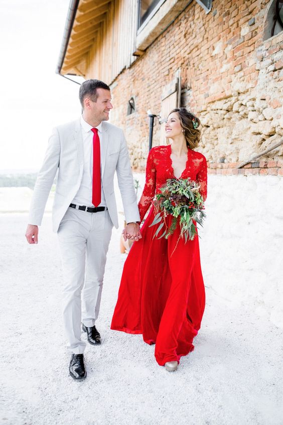 a red wedding gown with a lace bodice and sleeves and a plain skirt for a Christmas bride
