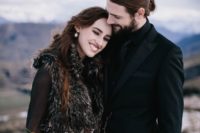 02 the bride rocking a dark fur coverup and the groom in black for a moody ceremony