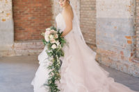 03 The bride was also wearing a rhinestone headpiece with ribbons and she was carrying a cascading bridal bouquet with blush blooms