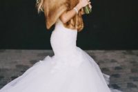 03 a mermaid wedding dress, a faux fur coverup, glam earrings and a bracelet for a chic bridal look