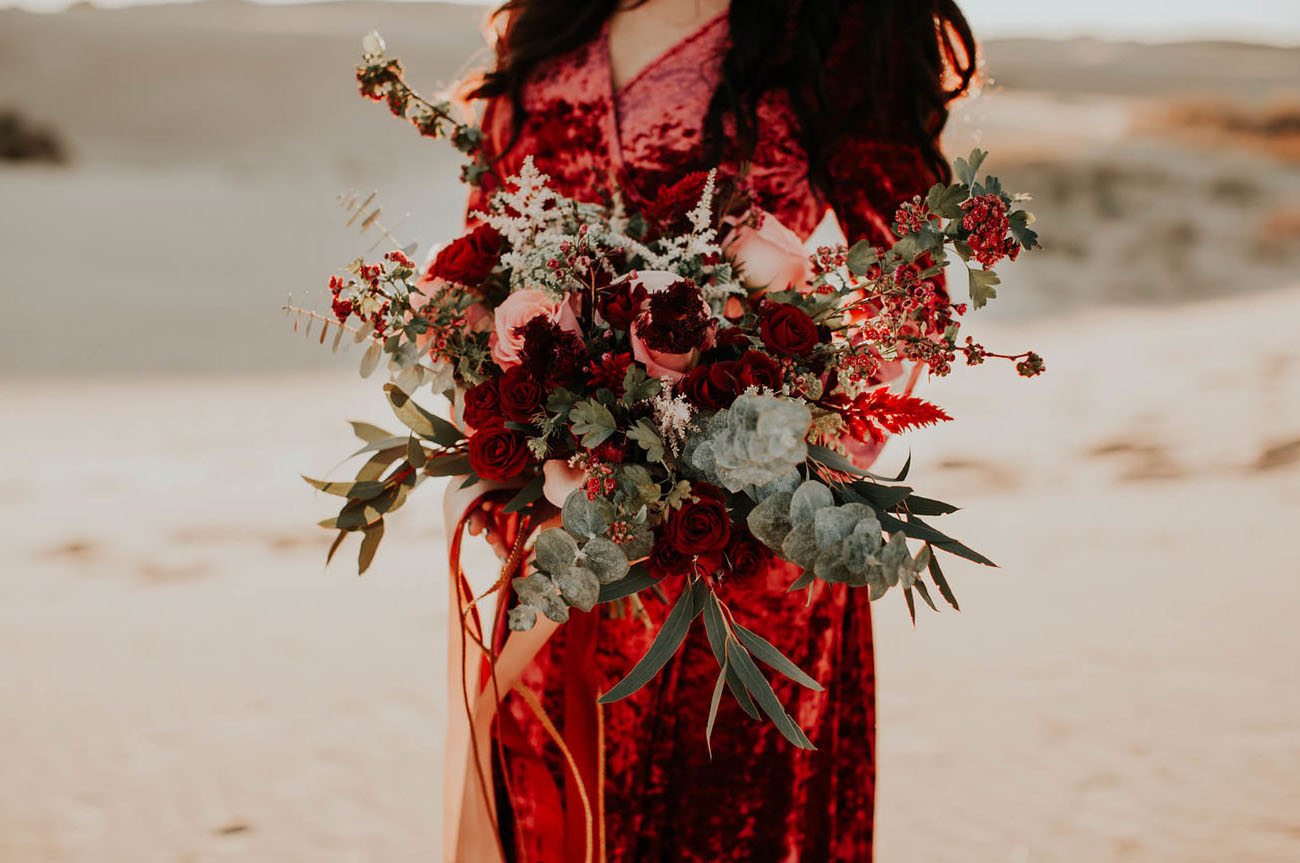 The bridal bouquet was created to complement her red velvet dress