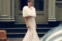04 an embellished wedding dress with a train, a white fur wrap, a jeweled headpiece and a bold lip