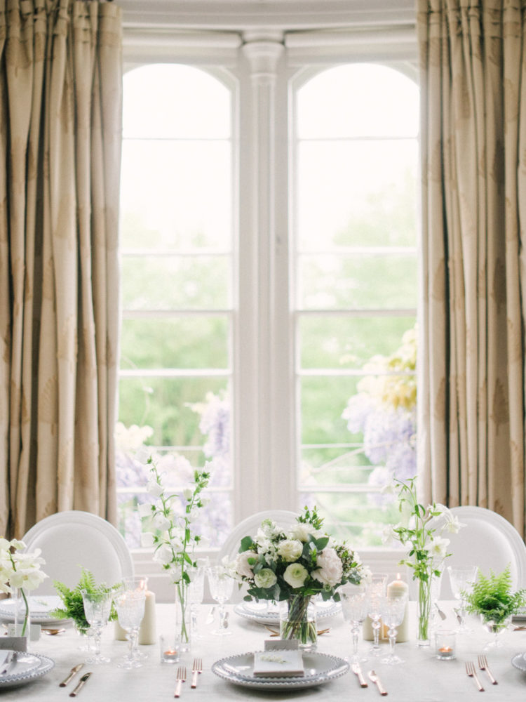 the wedding tablescape was neutral and simple, with neutral blooms and greenery