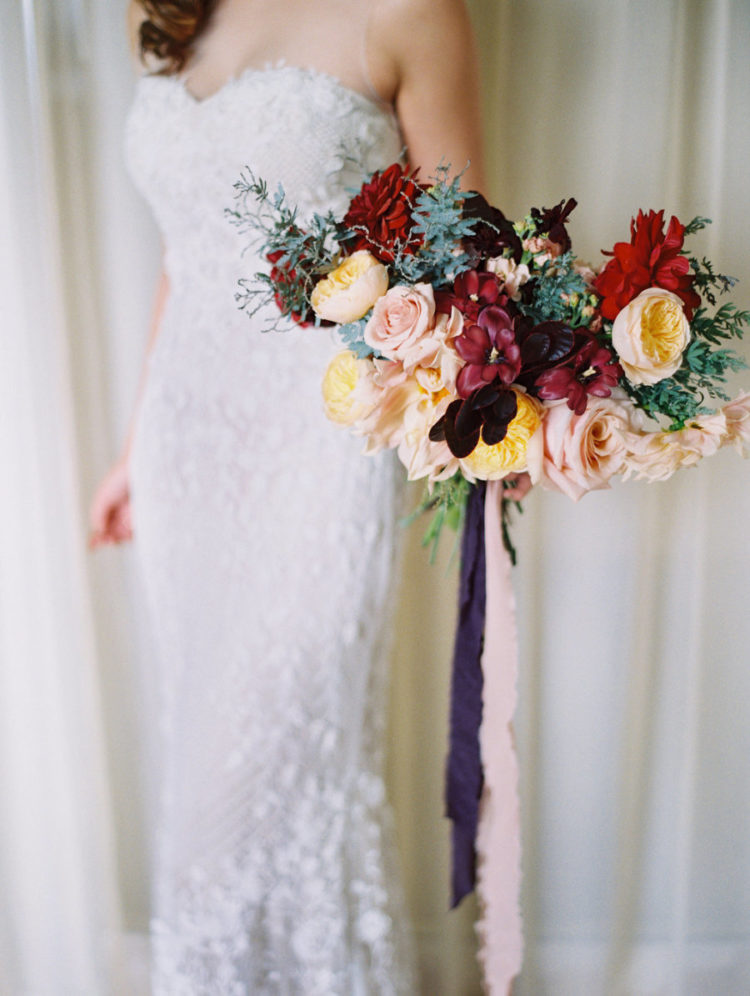 The bridal bouquet was a bold one, with red, dark plum and yellow blooms