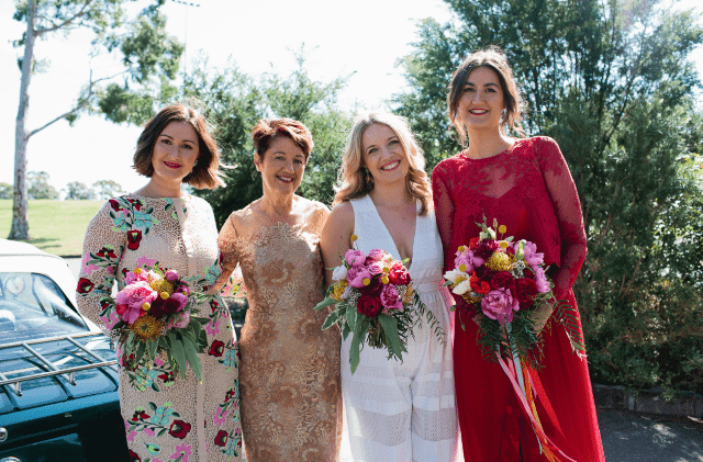 The bridesmaids were wearign mismatched dresses, a white striped one and a floral one