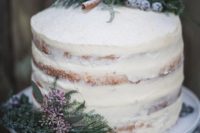 05 a beautiful and simple semi naked wedding cake topped with sugared blueberries, cinnamon sticks and evergreens