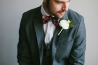 05 a groom in a grey suit and with a plaid tie for a slight but cute touch of the festive spirit