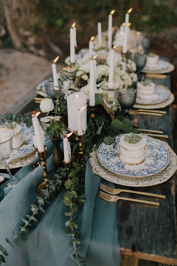 a muted blue table runner with eucalyptus for a winter coastal wedding