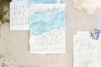 05 airy light blue watercolor wedding invitations with calligraphy and a raw edge for a seaside wedding