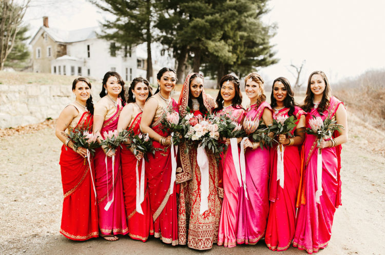 The bridal party tried the exotic and bold Indian clothes in red and fuchsia