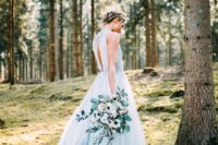06 a blue wedding dress with a slit on the back, a lace bodice and a flowy skirt looks ethereal