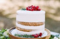 06 a holiday-inspired winter wedding cake topped with fresh raspberries for a Chrstimas wedding