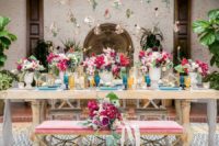 07 The wedding tablescape was done with bold colors – fuchsia, pink, blue, gold and burgundy