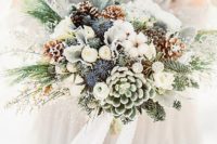 07 a gorgeous bouquet with snowy pinecones, thistles, succulents, evergreens and white cotton
