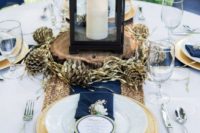 08 a gorgeous place setting with a gold sequin table runner, navy napkins, gilded pinecones