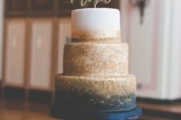 09 a glam wedding cake with navy, gold glitter and white and a calligraphy topper