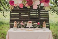 09 a paper flower backdrop for the cake table done in pink, fuchsia and white