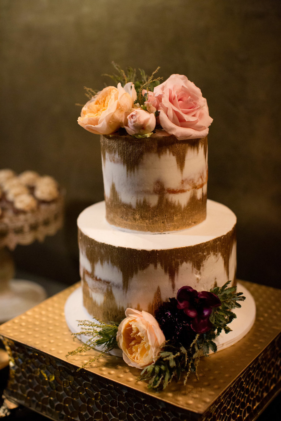 The wedding cake was ikat, with gold and white touches and fresh blooms