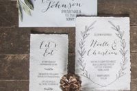 10 contemporary winter wedding invitations in neutrals, with black calligraphy and a raw edge