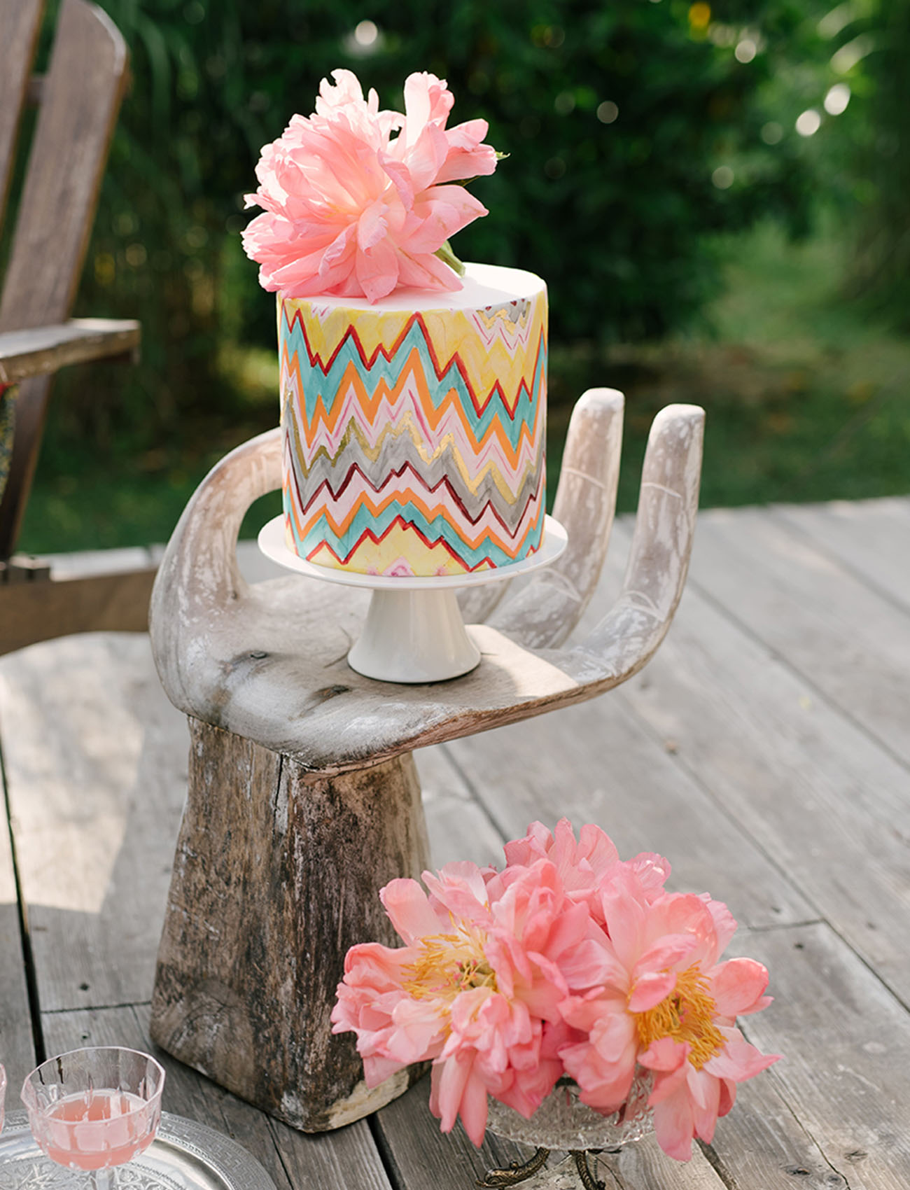 the wedding cake was a colorful one with bold geometric patterns and a fresh peony on top