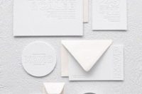 11 a minimalist all-white letterpressed invitation suite is a unique and very eye-catchy idea