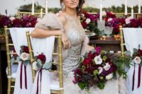 11 an embellished sleeveless wedding dress with a feather skirt, a faux fur coverup and statement earrings for a glam winter bride
