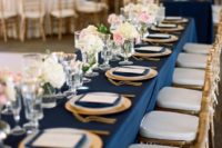 12 a chic table setting with navy napkins and a tablecloth, gold cutlery and chargers for a chic look